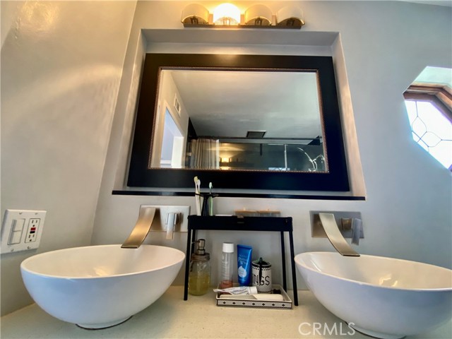 Luxurious en suite bathroom with double sinks and built in wall faucets