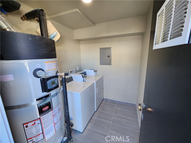 Common laundry room only shared by two other units: a 2BR and another studio.