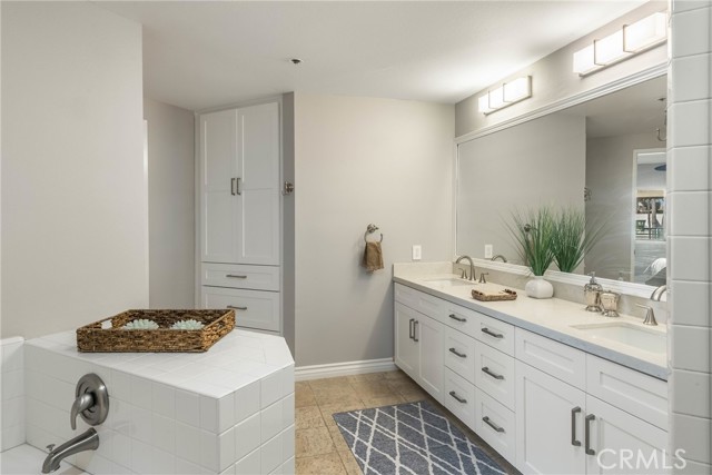 Amazing primary bathroom is huge for a 2 bedroom condo.  Enjoy frameless shower, dual vanities, new lighting, soaking tub and more