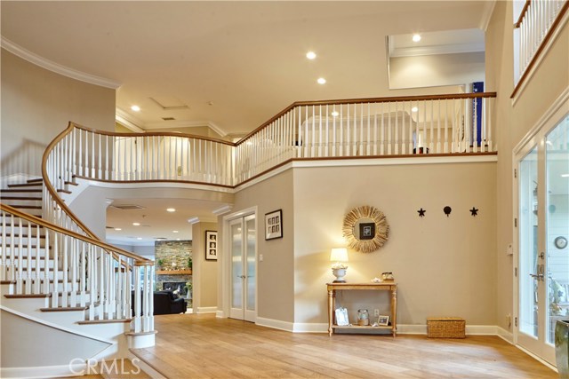 View of curved stairway leading to upper landing den/loft