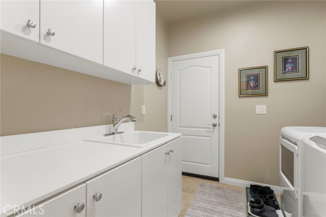 Laundry room with cabinet space and sink