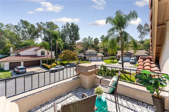 Just the right amount of space to set some chairs and a table and enjoy the view from the primary suite of the neighborhood and trees. Notice the custom chosen tile adding charm.