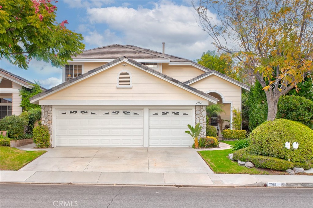23921 Hammond Court Valencia, California ***Location Location Location***Absolutely Gorgeous Upgraded Cul-de-sac Home***NO MELLO ROOS*** Low HOA Located in the sought-after neighborhood of Valencia Northbridge. A picture-perfect lush front yard leads you to the inviting front porch or the spacious three-car garage. Once you open the door, you can tell this home is special. Beautiful floors, custom paint, custom wall texture, high ceilings, and natural sunlight stream into the living room and dining room combination. The dining room has an upgraded chandelier and stunning views of the incredible backyard. The upgraded kitchen boasts tons of counter space, stainless appliances, a stainless hood, recessed lighting, an island, upgraded fixtures, upgraded countertops, upgraded cabinets, an eat-in dining area, and looks into the expansive family room and out into the tranquil backyard. The home was originally four bedrooms. The fourth bedroom was opened up to extend the family room, which is amazing. The family room is definitely the heart of the home. It has upgraded floors, crown molding, surround sound, and a cozy fireplace as its focal point. There is a large indoor laundry room with a sink and plenty of storage. There is also an upgraded bathroom to round out the first floor. Once upstairs you will find the three spacious bedrooms. The primary is large with high ceilings, plantation shutters, dual primary closets, and an ensuite bathroom. The ensuite bathroom has a separate tub and shower, dual sinks, and plenty of storage space. The upgraded hall bathroom is large with double sinks. The real showstopper is the backyard. It is an absolutely stunning private oasis. The attention to detail is incredible with multiple seating areas, abundant lush foliage, and a water feature. If there is such a thing as a Zen vibe this home has it. Upgraded A/C. Upgrades include but are not limited to; crown molding, wall texture, custom paint, flooring, lighting, and fixtures. There is an association pool close by. Close to shopping, dining, and many amenities. Everything about this home feels custom.