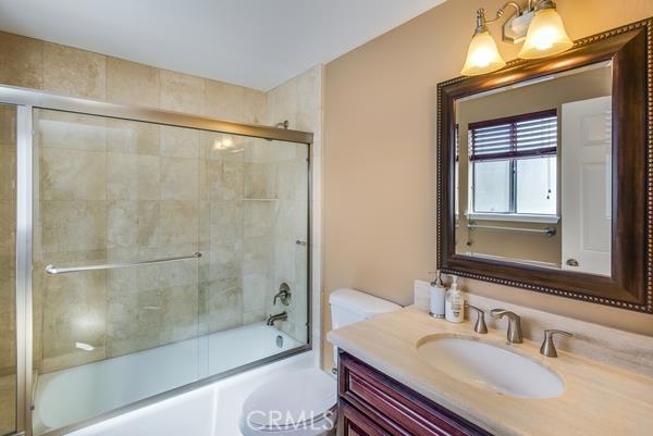Full bath connected to the bedroom at the end of the hallway.  Upgraded tile around the tub, and a beautiful counter top.