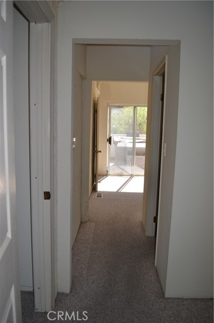 Hallway connects to the next room with walk-in closet