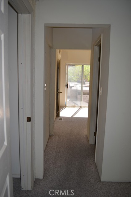 Hallway connects to the next room with walk-in closet