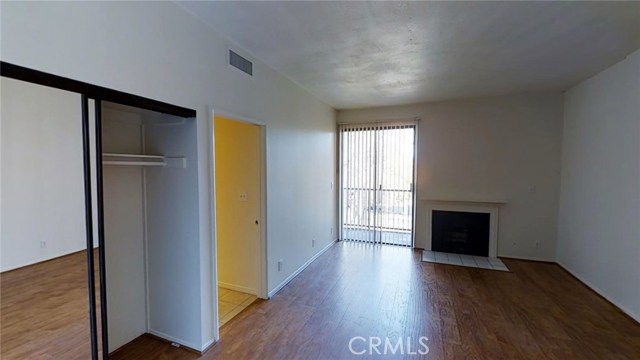 Master bedroom with fireplace, balcony and 3 closets (one is a walk in).