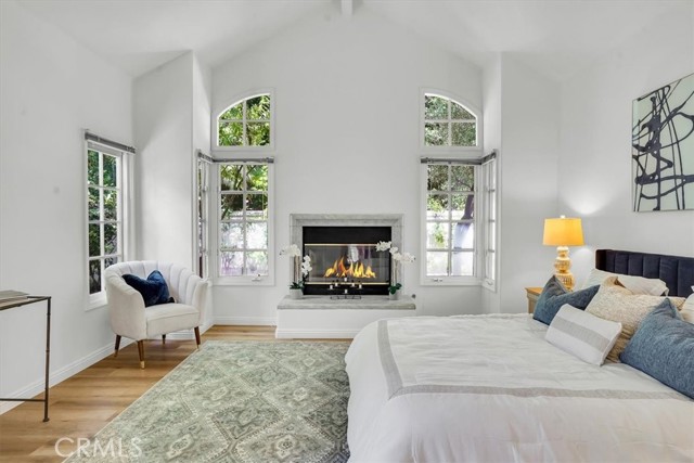 Master Bedroom with high ceilings and cozy fireplace