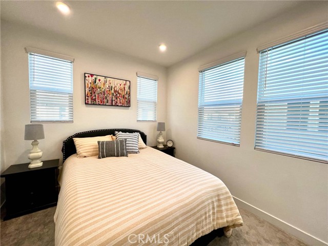 Corner bedroom with queen size bed.
