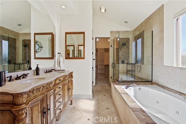 En-suite with a skylight and a window.