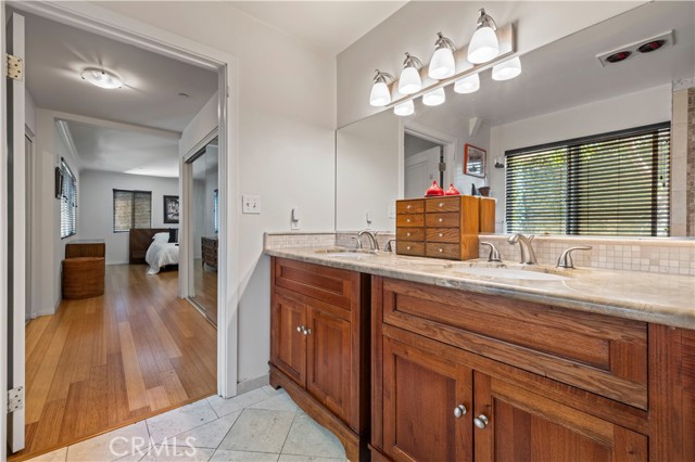 Main bathroom with dual sinks and stone countertops