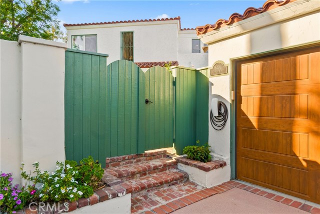 The gated private entry is a welcoming feature to the home.