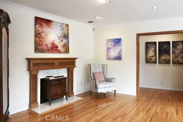 Red-oak mantle and Calacatta Gold marble fireplace; dimmable ceiling lights
