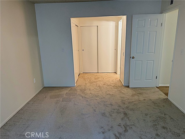 Primary looking towards the wall of closet space and primary bath area.