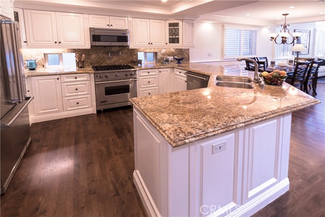 Kitchen with ample counter space, Viking appliances, large pantry, and breakfast bar