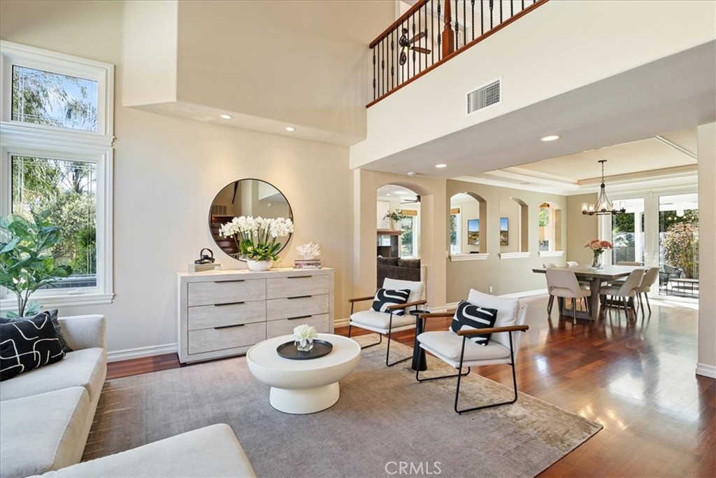 Welcome to 4 Bastia—an entertainer’s dream in the sought-after Marina Hills community of Laguna Niguel. This beautifully upgraded 4-bedroom, 3-bathroom home is on a lushly landscaped pie-shaped lot designed for effortless indoor-outdoor living. The private backyard retreat features a Pebbletec salt-water pool and spa with a beach entry, a stacked stone finish, and a waterfall. Relax poolside or host unforgettable gatherings at the custom outdoor kitchen with granite counters, a Lynx built-in BBQ, bar seating, and stylish paver hardscaping. There's even a spacious grassy area for outdoor games, pets, or peaceful lounging. The interior layout has been thoughtfully expanded to create an open-concept great room, combining a generous family room and a fully remodeled chef’s kitchen—a rare find in the neighborhood. The kitchen features a massive island with seating, a Viking professional 6-burner range with griddle and warming lights, double ovens, a newer GE Monogram built-in refrigerator, a Bosch dishwasher, and beautiful custom cabinetry.  Downstairs, you'll find a lovely bedroom and a stylishly updated bathroom—ideal for guests or multigenerational living. French doors in the dining room lead to an outdoor pergola-covered patio perfect for al fresco dining in the beautiful beach climate. Upstairs, the primary suite offers vaulted ceilings, plantation shutters, mirrored closets, an en-suite bathroom, and serene views of your resort-style yard. Adjacent to the primary suite is a spacious loft with a flexible space perfect for a home office. The secondary bedrooms also include shutters, ceiling fans, and newer carpets, and they share an upgraded bathroom featuring subway tile, mosaic accents, and chic designer touches with a bathtub and shower.  A fabulous 3-car garage offers built-in cabinetry, overhead storage, built-in compressor for power tools, and a paver-lined driveway and walkway. Residents of Marina Hills enjoy access to so many amenities: a Jr. Olympic pool, spa, tennis courts, beautiful clubhouse, parks, playground, and the Salt Creek Trail—all just minutes from world-famous beaches such as Salt Creek Beach, Laguna Beach, Dana Point Harbor (undergoing a $500 million renovation), Dana Point's Lantern District, shopping, and top-tier dining. Just down the street is a wonderful shopping center with Starbucks, Albertsons, CVS, medical, retail, and so much more. This home truly has it all—luxury, location, and lifestyle. Schedule your private tour today!