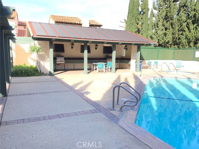 Covered community pool patio with barbecue