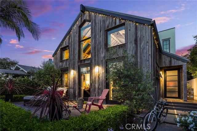 752 Palms Boulevard Venice, California Once you descend on this privately secured front yard, you will be captivated by the home’s serenity. This contemporary farm house style with reclaimed wood exterior is carried through to the welcoming foyer and open living floor plan, high ceilings and loft. Retractable doors open to a large court yard for indoor/outdoor living and entertaining large gatherings. The cook’s kitchen has a 6 burner cook top, built in Miele’ coffee maker, warming oven/convection/microwave plus a large Thermador oven and 48” built in refrigerator. There is one main floor bedroom with on suite bath and two bedrooms with on suite baths plus office upstairs. Built and designed 6 years ago with exquisite finishes which are apparent in every detail. Designer wall papers, light fixtures, stone, tile, wood, & plumbing fixtures pull the dramatic touches all together. The home is located on one of Venice’s coveted streets close to Abbot Kinney, situated on a street to alley lot and has an ADU with kitchenette and separate entry in the back. Gated 3 car oversized garage, storage area outdoor shower.
