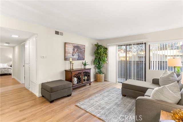 Spacious living room with sliding glass doors leading to the patio. Very light and bright with corner windows.
Notice the new luxury vinyl floors and new interior paint.