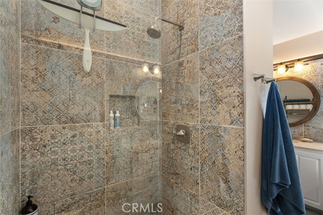 Large Walk-In shower with unique tile feature throughout