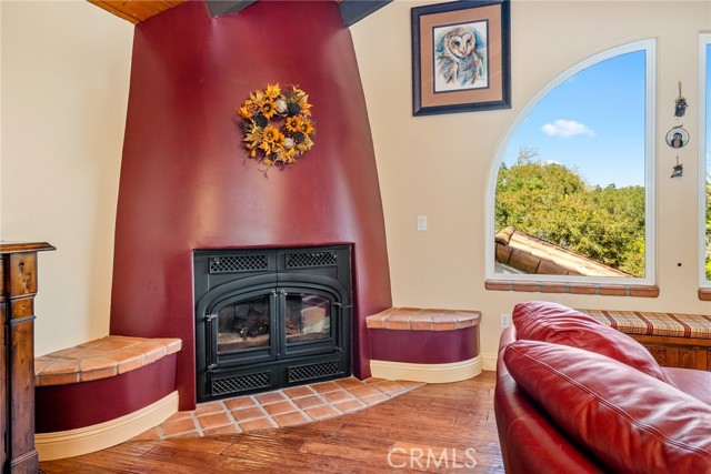 Beautiful, custom wood burning fireplace bookended by built in seating.