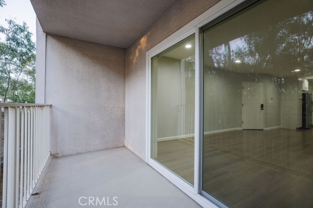Living room has a sliding door that opens to a private balcony