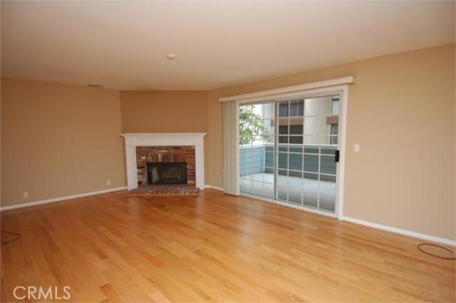 LIVING ROOM WITH FIREPLACE AND LARGE BALCONY