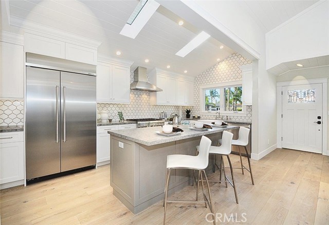 Gorgeously remodeled kitchen with expensive marble backsplash & top of the line appliances
