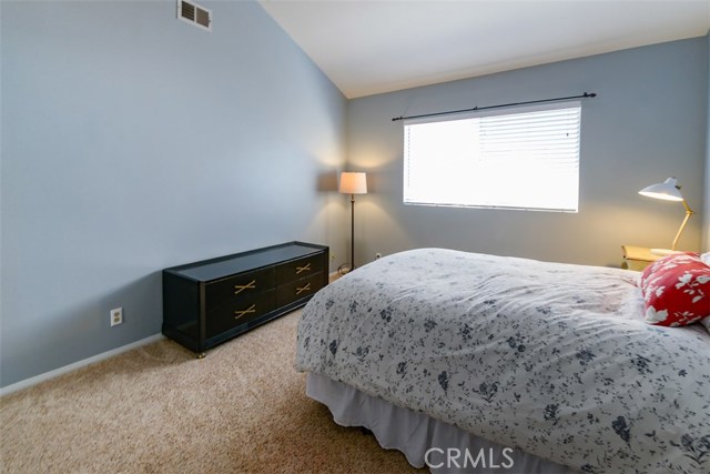 Second bedroom with another full closet and vaulted ceilings.