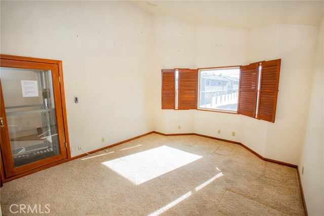 Bedroom #3: Vaulted ceiling and Elevator access door.