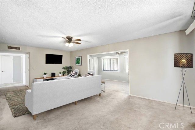 Virtually staged Living Room looking into Lanai