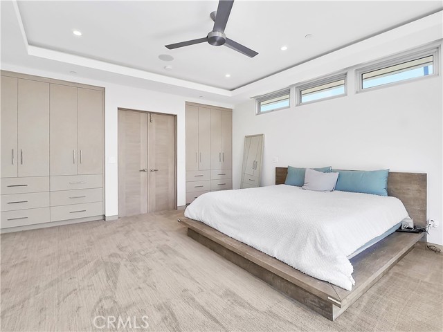 Master bedroom with built-in storage and his and her closets.