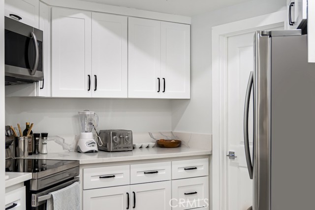 Remodeled kitchen with stainless steel appliances, quartz countertops, newer cabinetry