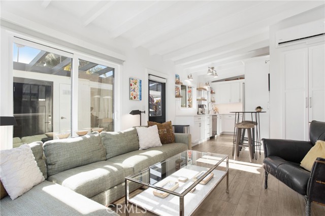 Sunny orientation with two floor to ceiling sliding glass doors.