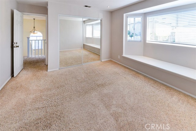 Same front bedroom looking to the hallway and stairs.