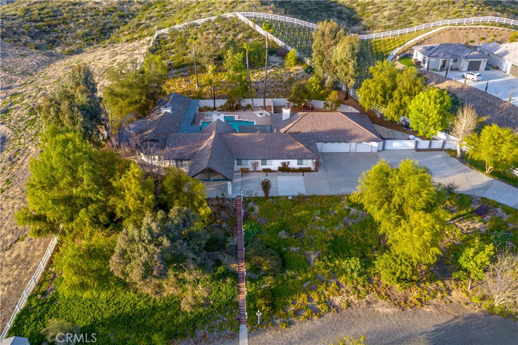 42325 Casa Verde Temecula, California Tucked away in the heart of Temecula Wine Country is one of the most magnificent privately gated estates offering complete privacy and tranquility. When you want it all! Rare single level living, 2 homes and granny suite, on completely secluded full two 2.45 acres of diamond resort grounds. The moment you drive through the gates, you will be overwhelmed with wonderment and admiration. Every detail has been refined and cultivated to create the ultimate in luxury without compromising comfortable living. The best times will be realized with one of the most incredibly designed grounds/amenities including resort pool and spa, 2 bedroom, 2 bath guest house with its own address, pool shower, complete outdoor barbecue and outdoor pavilion. From the exquisite formal parlor to the gourmet chef’s kitchen, family room with fireplace, formal and casual dining areas, professional office, exercise room, plus a granny suite and master overlooking your pictorial surroundings, every room radiates warmth and splendor authenticity. The home is centered around the noteworthy, amazing and spectacular views of the Temecula valley surrounded by several blossoming fruit and mature trees, pristine landscaping with a gazebo and playground. This astonishing estates 6 car garage with custom floor tiles and RV parking add to the desirability of this stunning manor. With close proximity Temecula wineries, downtown and attending some of the best schools, this home offers it all!