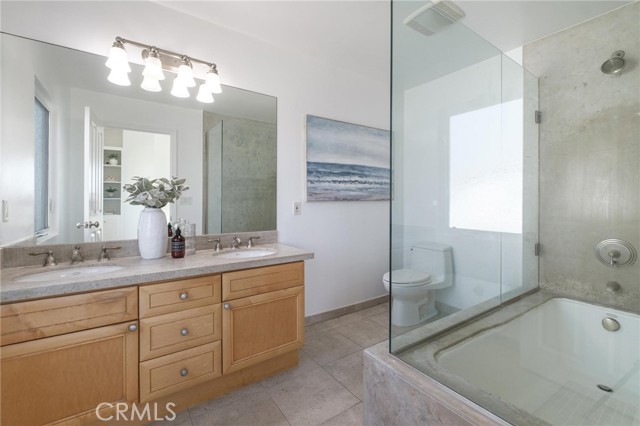 Primary bathroom with lime stone shower/tub and counter top.