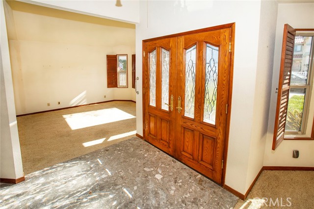 Inside Double Door Entry, Stone flooring, Living Room to right.