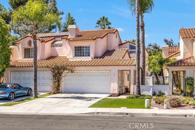 Welcome to this stunning two bedroom, two and a half bath home located in the desirable Saltaire community of Laguna Niguel. Upon entering, you will be greeted by beautiful vaulted ceilings and an abundance of natural light that fills the main living area, complete with a cozy fireplace.The open concept layout seamlessly connects the formal dining area to the kitchen, which features granite countertops and a charming breakfast nook. Upstairs, the spacious primary suite boasts a private balcony with serene views of surrounding trees. The second bedroom also enjoys high ceilings and an ensuite bathroom. Outside, the patio area is perfect for entertaining with plenty of room for outdoor activities. For added convenience, the home includes an enclosed laundry room on the main floor. This home is situated in a prime location, close to shopping, restaurants, hiking trails, dog park and access to excellent schools.