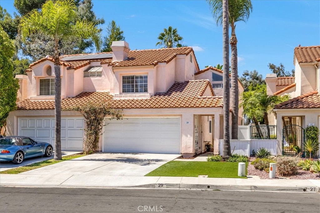 Welcome to this stunning two bedroom, two and a half bath home located in the desirable Saltaire community of Laguna Niguel. Upon entering, you will be greeted by beautiful vaulted ceilings and an abundance of natural light that fills the main living area, complete with a cozy fireplace.The open concept layout seamlessly connects the formal dining area to the kitchen, which features granite countertops and a charming breakfast nook. Upstairs, the spacious primary suite boasts a private balcony with serene views of surrounding trees. The second bedroom also enjoys high ceilings and an ensuite bathroom. Outside, the patio area is perfect for entertaining with plenty of room for outdoor activities. For added convenience, the home includes an enclosed laundry room on the main floor. This home is situated in a prime location, close to shopping, restaurants, hiking trails, dog park and access to excellent schools.