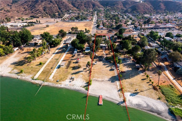 Own a bit of History! Per seller, this amazing waterfront property was once owned by world famous actor, Bela Lugosi. This 1.39-acre property has great potential with over 100 feet of beach on Lake Elsinore. Currently, the property consists of one "stick built" single family residence (2 BR, 1 BA, approximately 1000 sf, with new dual-pane windows in 2015 and new roof in 2010), one manufactured home on permanent foundation (2 BR, 2 BA, approximately 1500 sf, custom alum-a-wood porches in both front and back, new Guardian Energy Star roof in 2021, new upgraded rain gutters with screened covers in 2021, new Trane Air Conditioner system in 2016, reinforced earthquake bracing), a 792 sf over-sized garage/workspace with insulated steel housing inside and outside (which includes an additional restroom), and a 1 BR, 1 BA trailer with hook-ups.