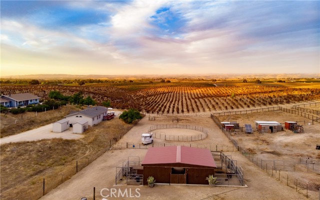 Four stall barn each with a paddock, round pen and pasture area