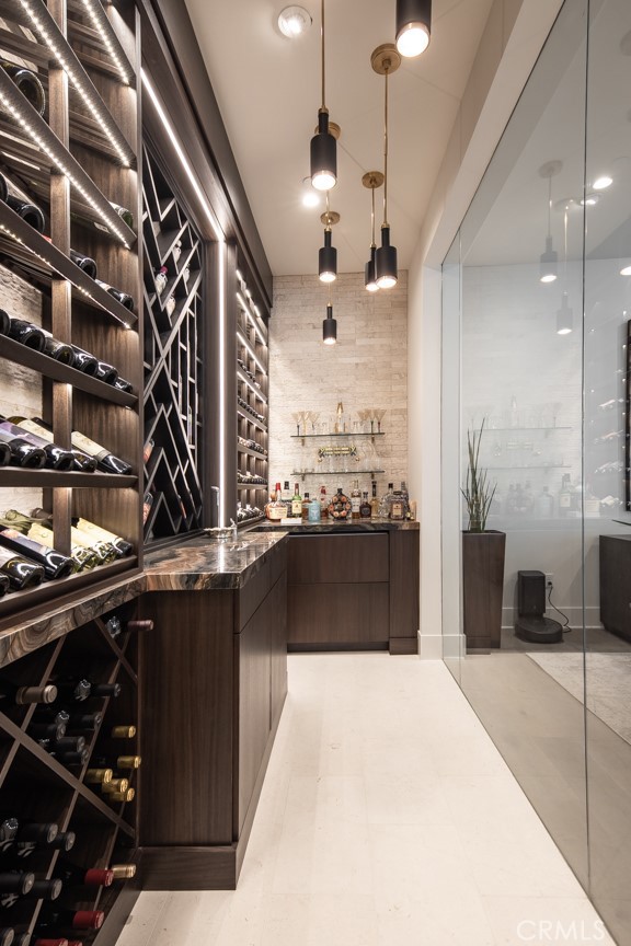 C1 floorplan wine storage room. Please note that this photo shows a completed, private residence with custom features, not the home under construction. Buyers have the option of selecting finishes and upgrades throughout the building process.