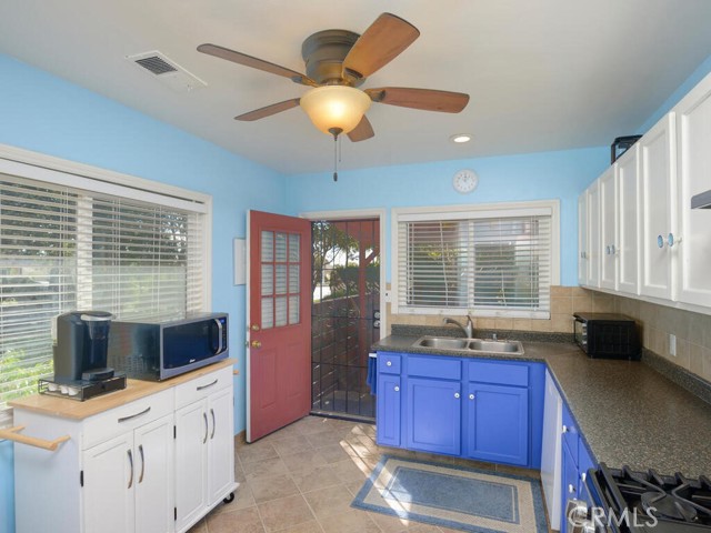 Another view of kitchen with door that leads to side yard