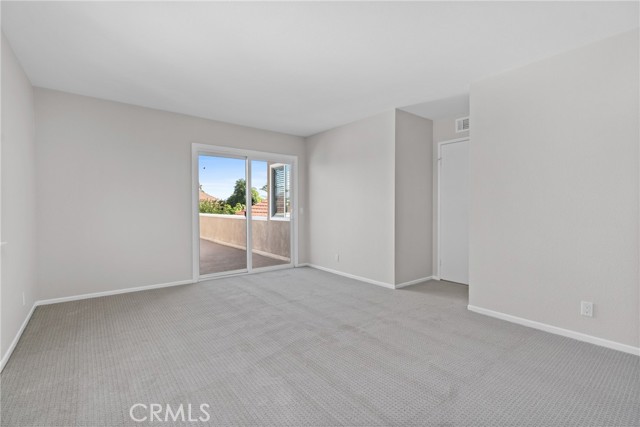 One of the secondary bedrooms has dual pane sliders to a large balcony overlooking the backyard!
