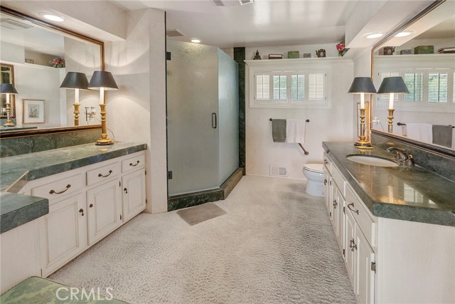 Primary Bathroom with large shower and double vanity areas