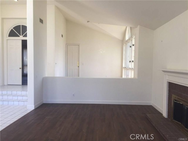 Living room with dining room in background leads to kitchen Living room with dining room in background leads to kitchen