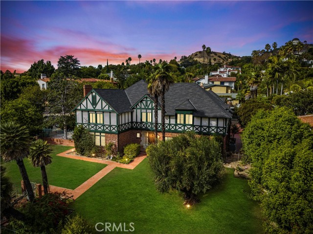 5079 Los Feliz Boulevard Los Feliz, California In 1933, Legendary architect A. Godfrey Bailey was commissioned to design this extraordinary English Tudor Revival on a sprawling half an acre of grounds. Completely private and comfortably set behind a gated entry, the South facing 5,200sqft. home highlights breathtaking original details with impeccable craftsmanship. The dramatic entry opens into a Grand Foyer and a custom staircase leading upstairs. The oversized Living Room is adjacent to the formal entry and highlights custom millwork, crown moldings and custom fireplace. In addition to the formal dining room, the main level also features a library room, spacious family room w/fireplace and an oversized Chef’s kitchen w/butler’s preparation room. Natural light envelopes almost every corner of the interior, most notably off of the Living Room, Kitchen, and Family Room. While most of the bedrooms have direct access to their own bathrooms, the Master Suite is spacious and is adjacent to a private covered patio. The Grounds are truly remarkable and highlight mature greenery for additional privacy. The resort style pool is gated and accessed through the main home. Vehicles enter through the oversized driveway and motor court via Nottingham. Above the detached 3 Car Garage, there is appx. 600sqft of additional living space with its own full bathroom. Additionally, the home holds a significant place in U.S. History as it is currently owned by the family of the 34th Treasurer of the United States under President Nixon. Here is a once in a lifetime opportunity on this priceless possession.