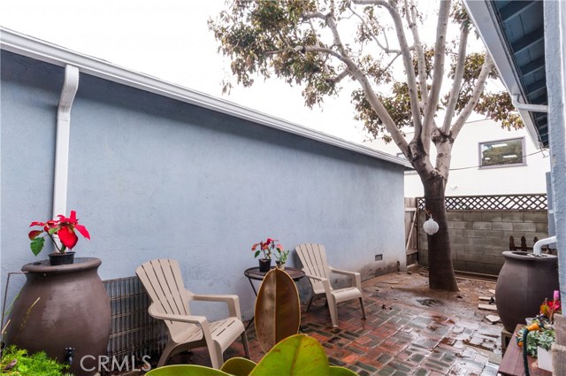 Patio area in between garage and front unit. There is a one car space and its own door for each of the three apartments.