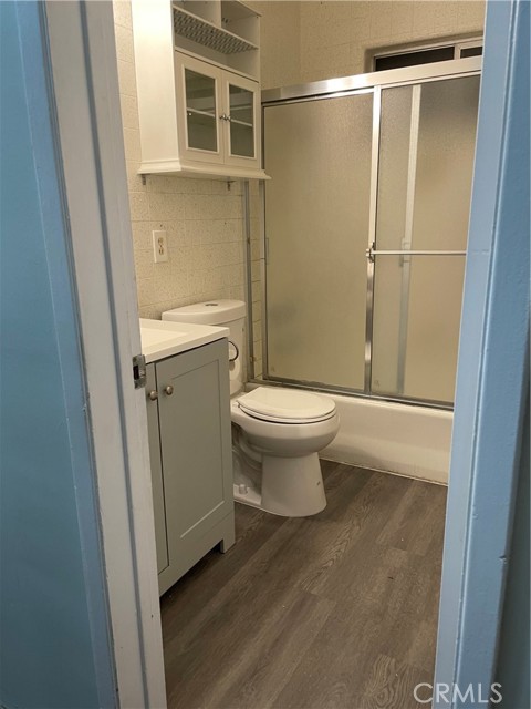 Full bathroom with new flooring, sink and toilet